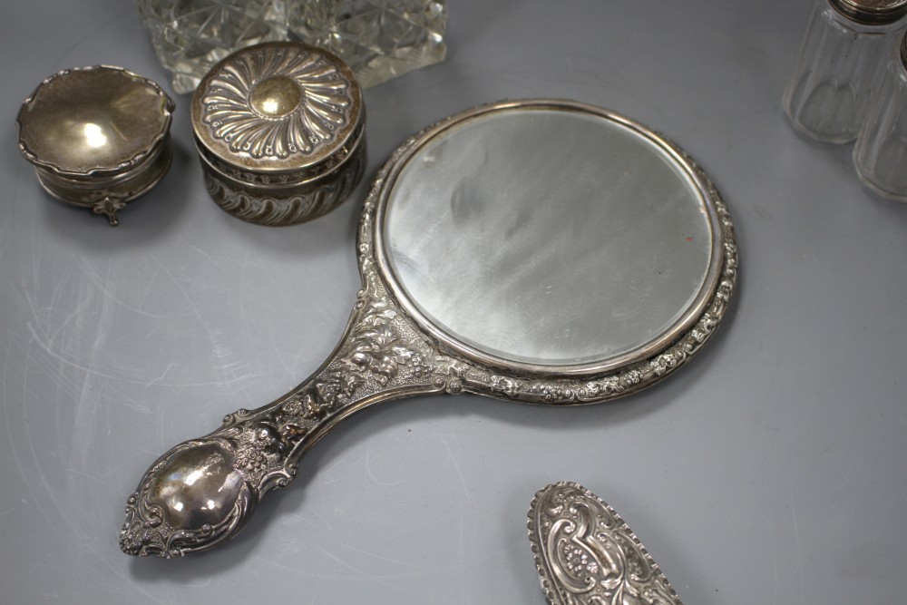 A late Victorian silver circular box and cover, a pair of similar silver mounted glass scent bottles, etc